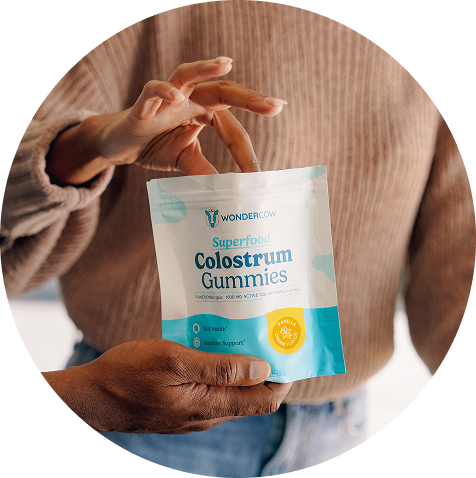 Woman holding Wondercow Colostrum Gummies