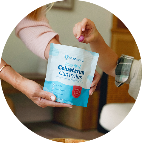 Woman holding Wondercow Colostrum Gummies